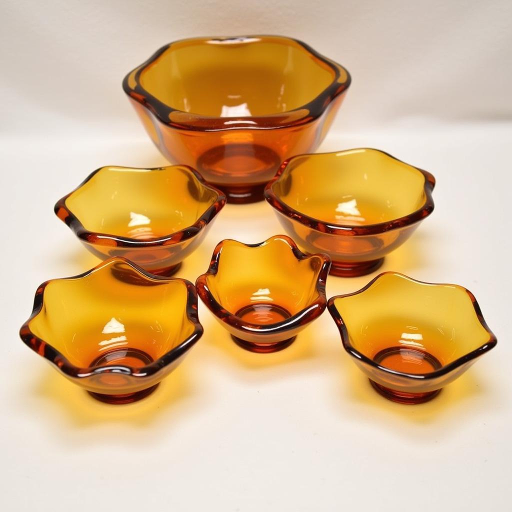 A collection of antique Art Deco amber glass bowls in various shapes and sizes