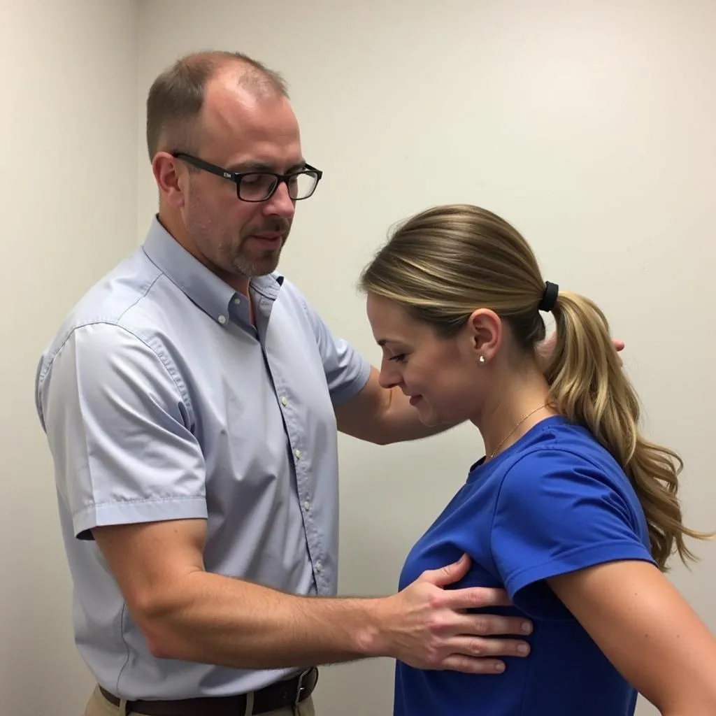 Chiropractor guiding a patient through exercises