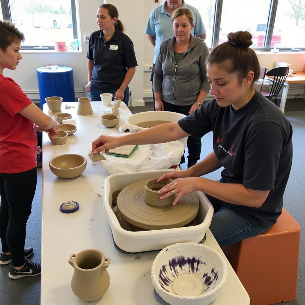 Artist demonstrating pottery at the Little Falls Art Fair