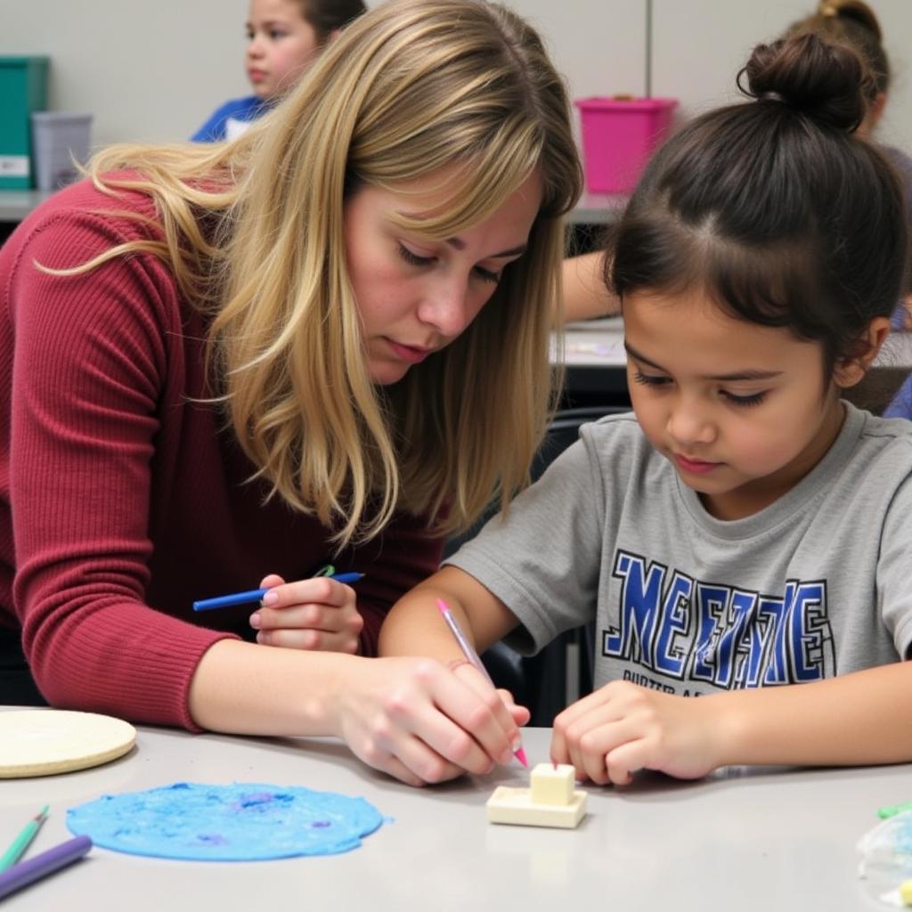 Instructor Guiding Student at Mattie Rhodes Art Camp