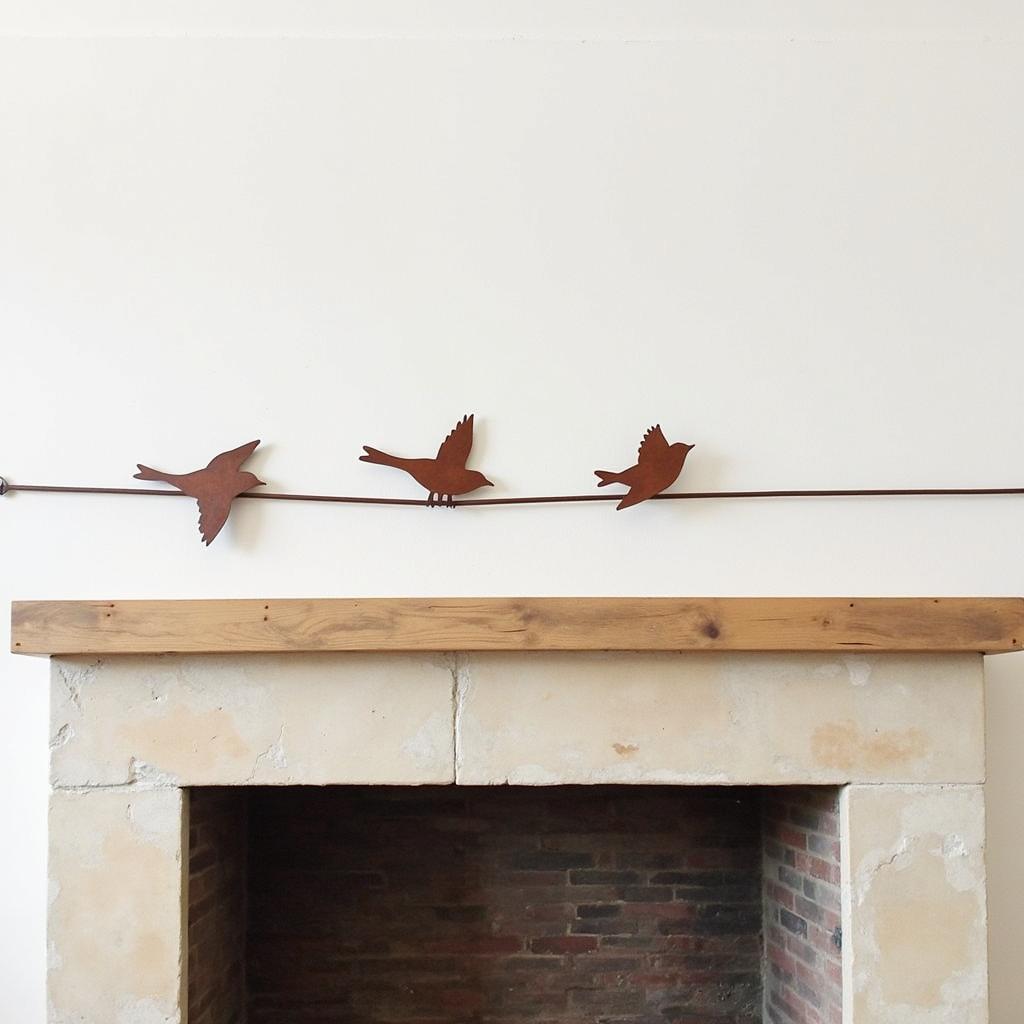 Metal Bird Wall Art Displayed Above a Fireplace