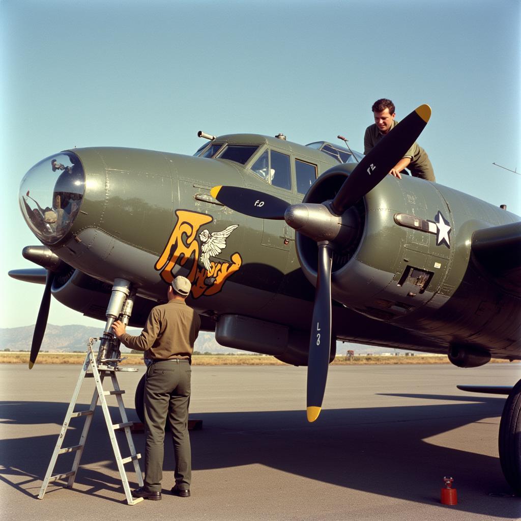 A World War II airplane mechanic painting nose art on a bomber