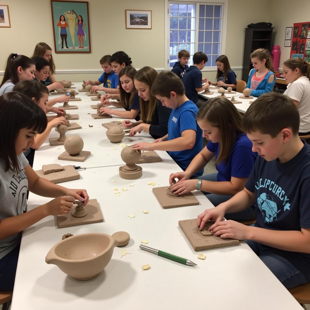 Students working on clay sculptures at art camp in Woodland Hills