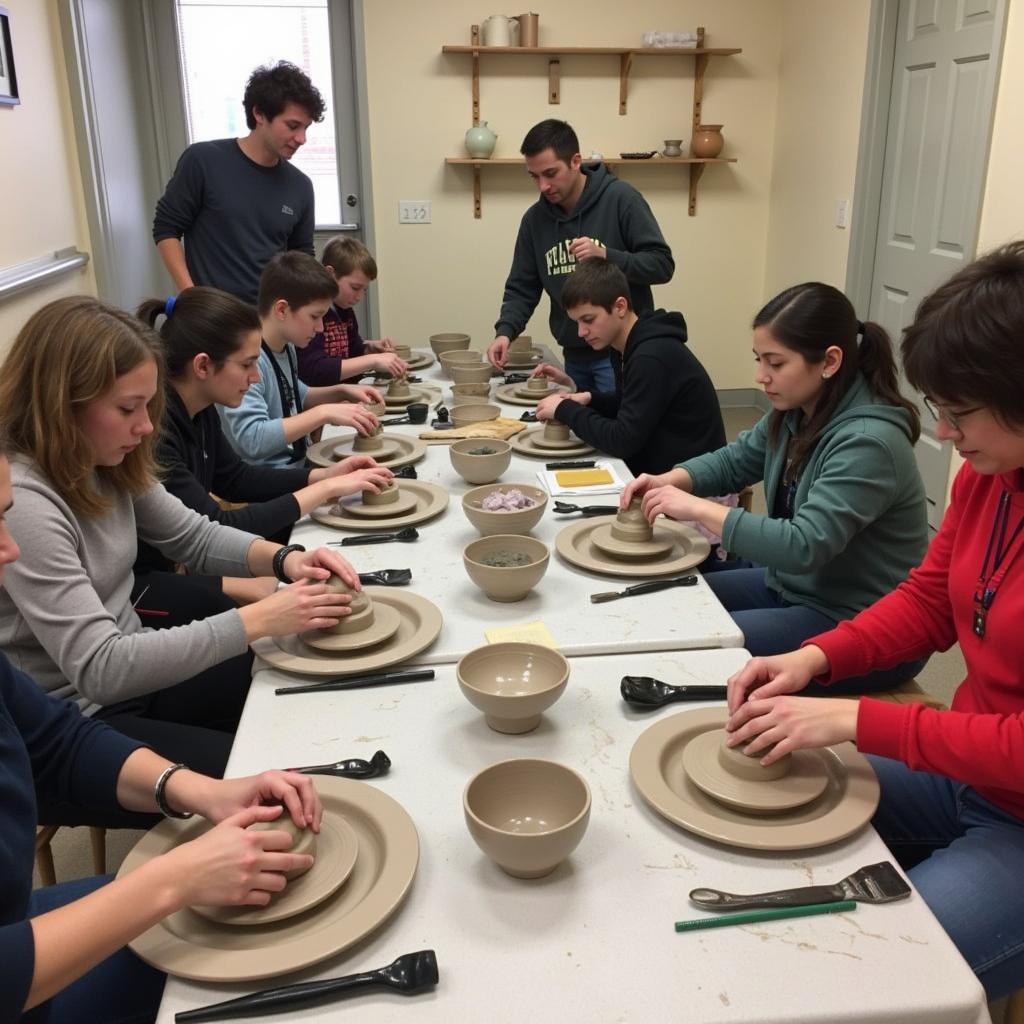 Attendees participating in a pottery workshop at the Arts and Crafts Conference.