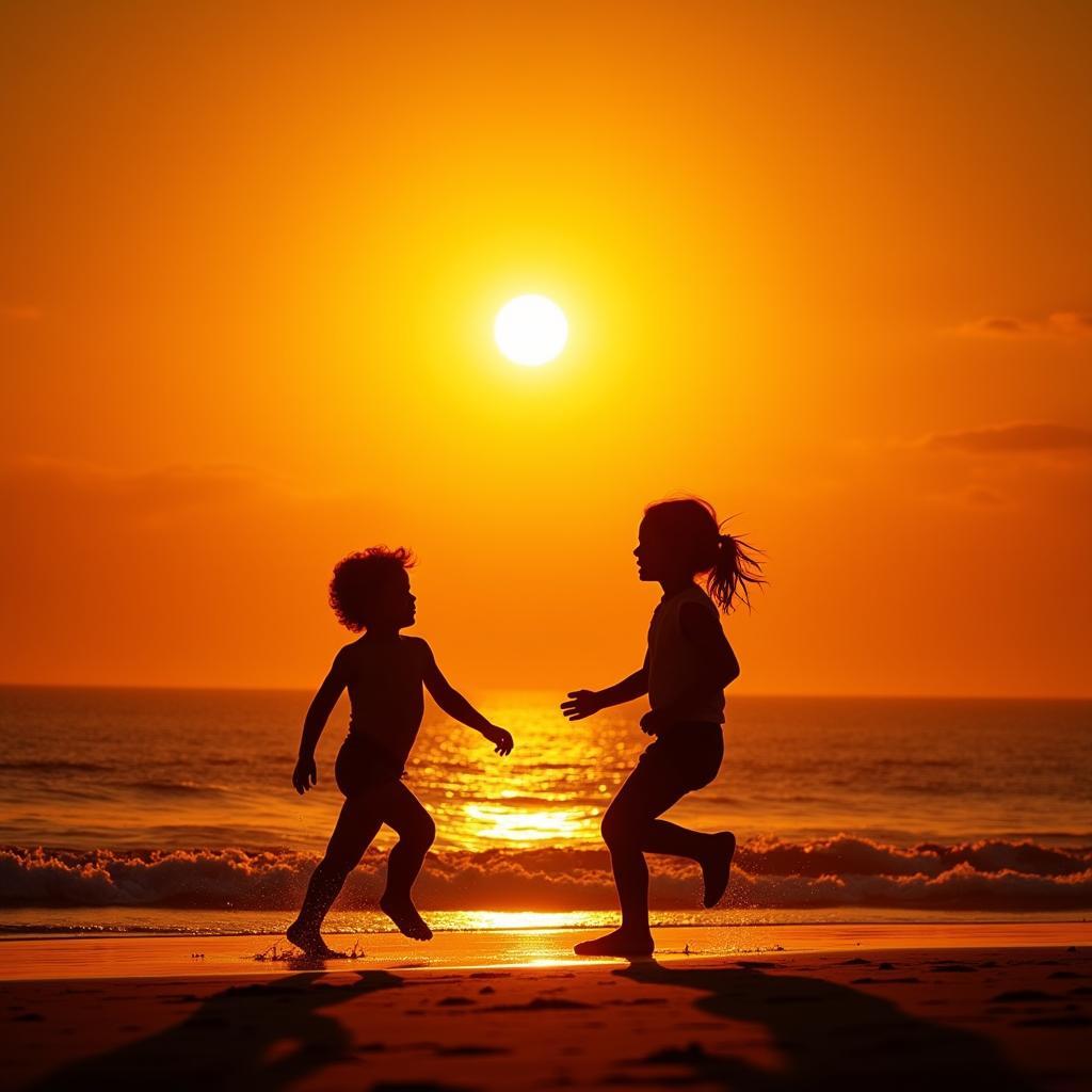 Two children playing on a beach during golden hour, their silhouettes outlined against the setting sun.