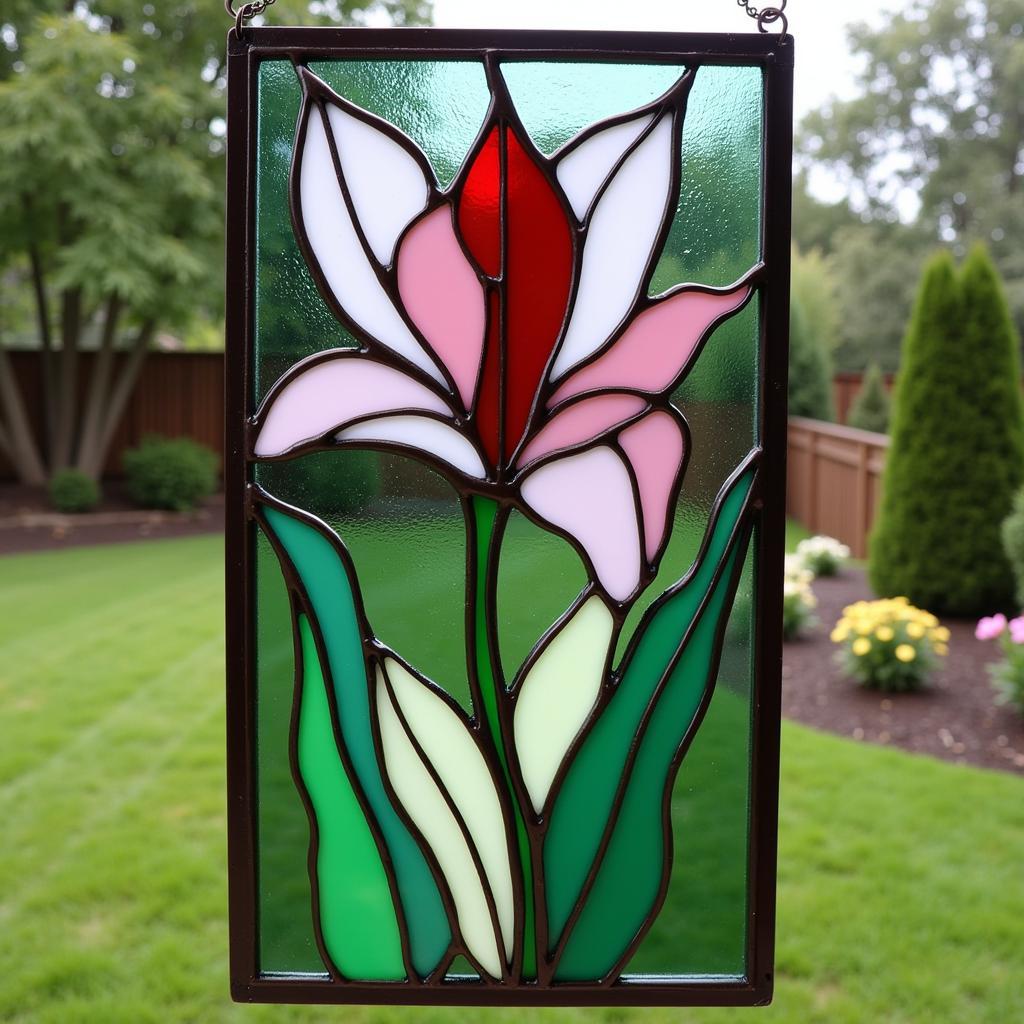 DIY stained glass flower panel for a garden setting.