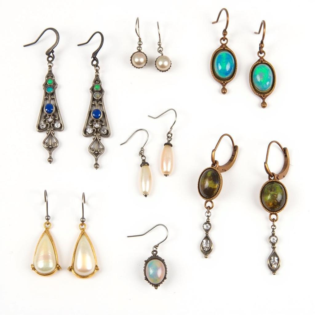 Art Nouveau earrings crafted from various metals and adorned with gemstones like opals and pearls.