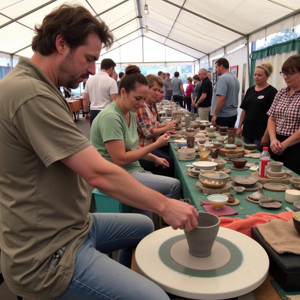 Artist demonstrating pottery techniques at Custer Arts and Crafts Show