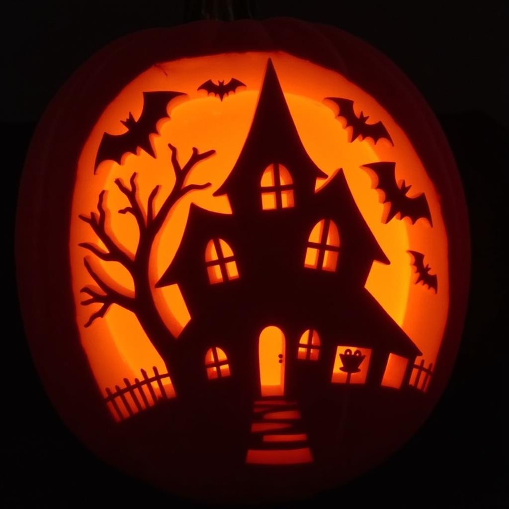 Intricate pumpkin carving using a Halloween stencil.