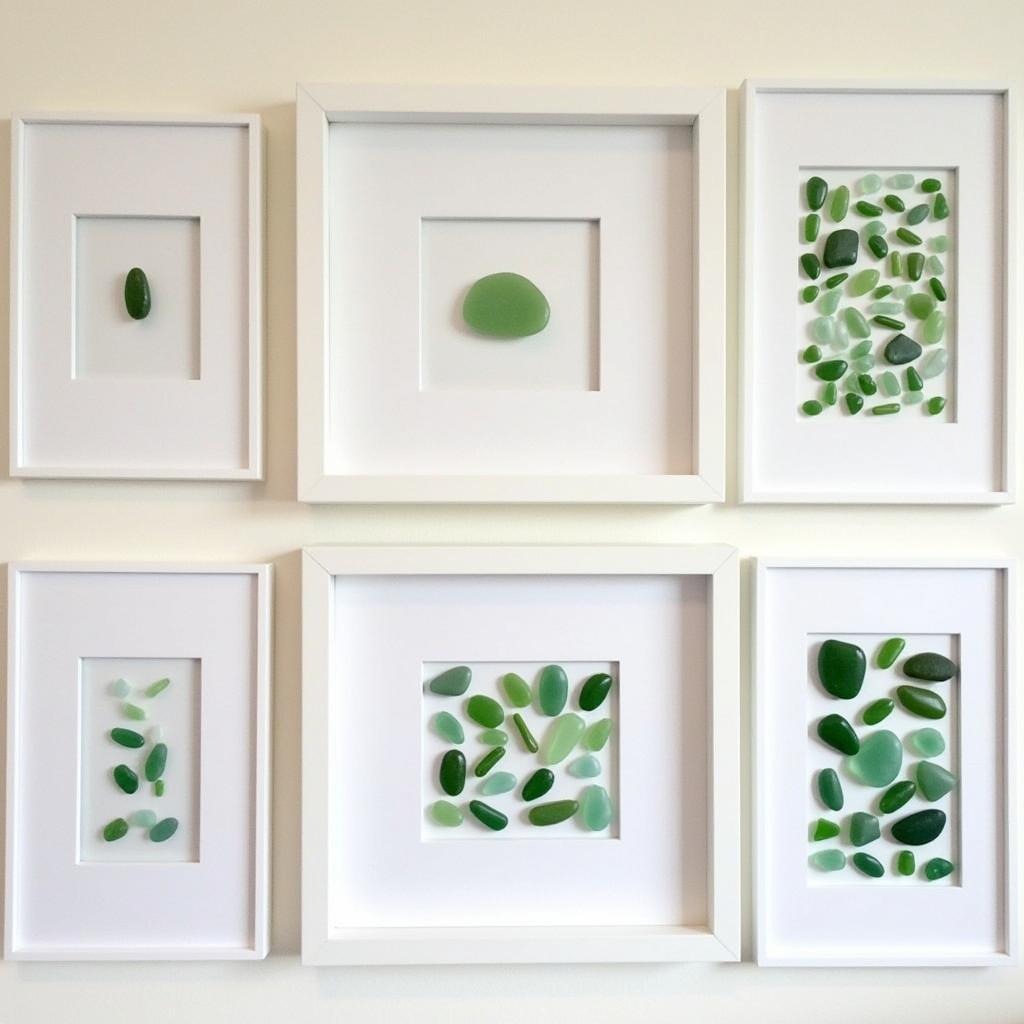 A collection of authentic sea glass framed art pieces showcasing various designs and colors.