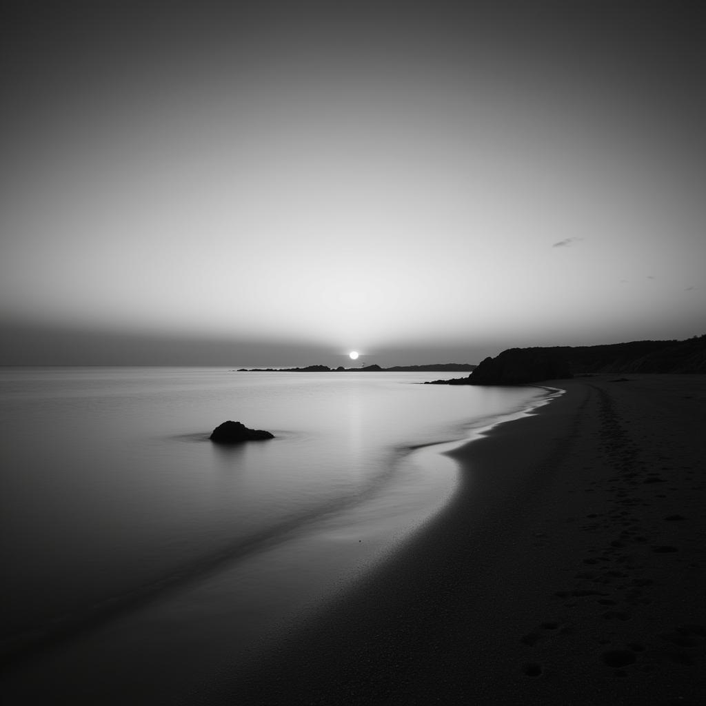 Minimalist black and white photograph of a tranquil coastal scene at sunset, ideal for contemporary wall art.