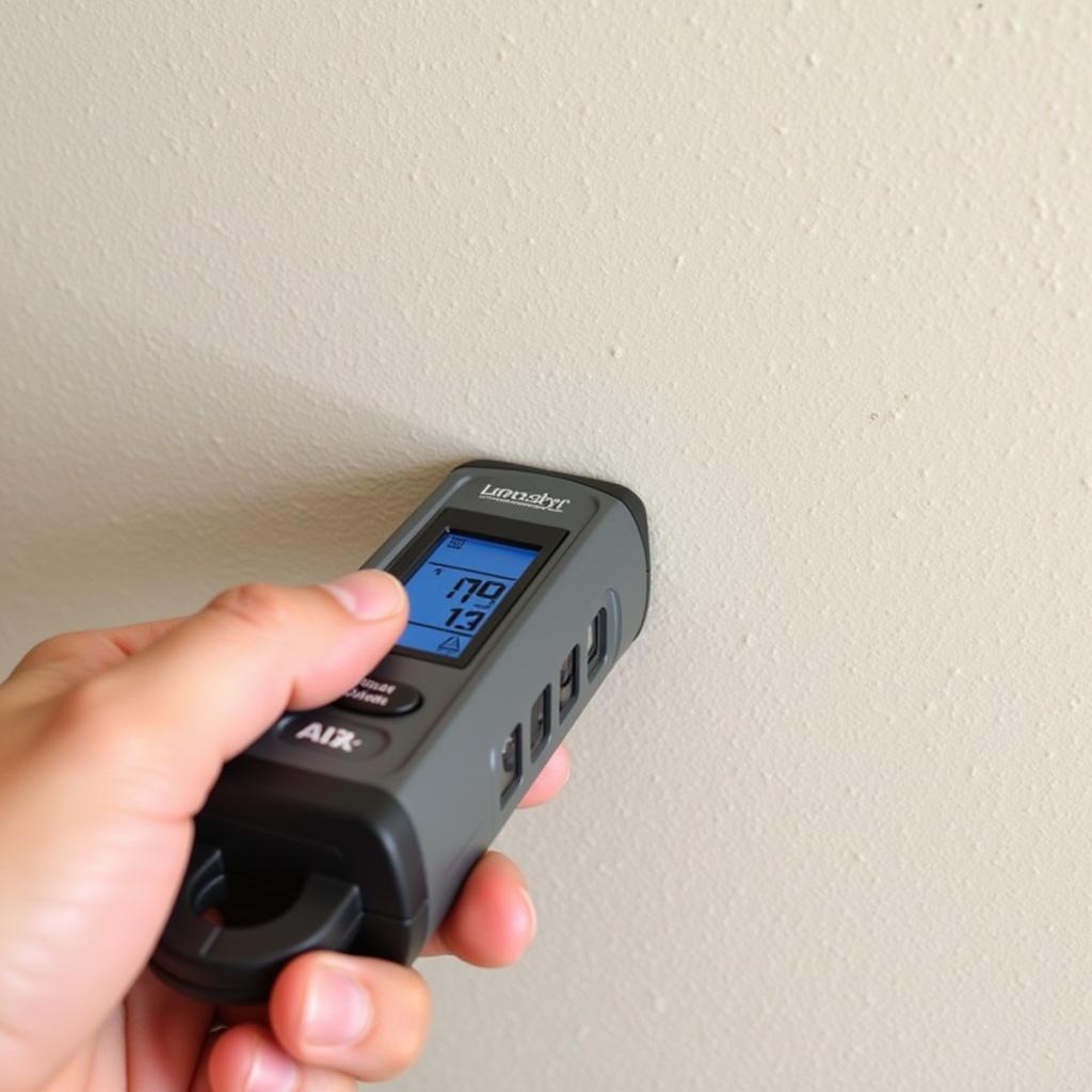 Close-up of a stud finder being used on a wall to locate studs before hanging metal wall art.